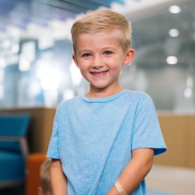 Young boy smiling in Children's Nebraska lobby.