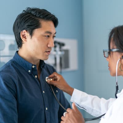 Provider listening to patient's heart.