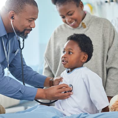 Provider listening to patient's heart.