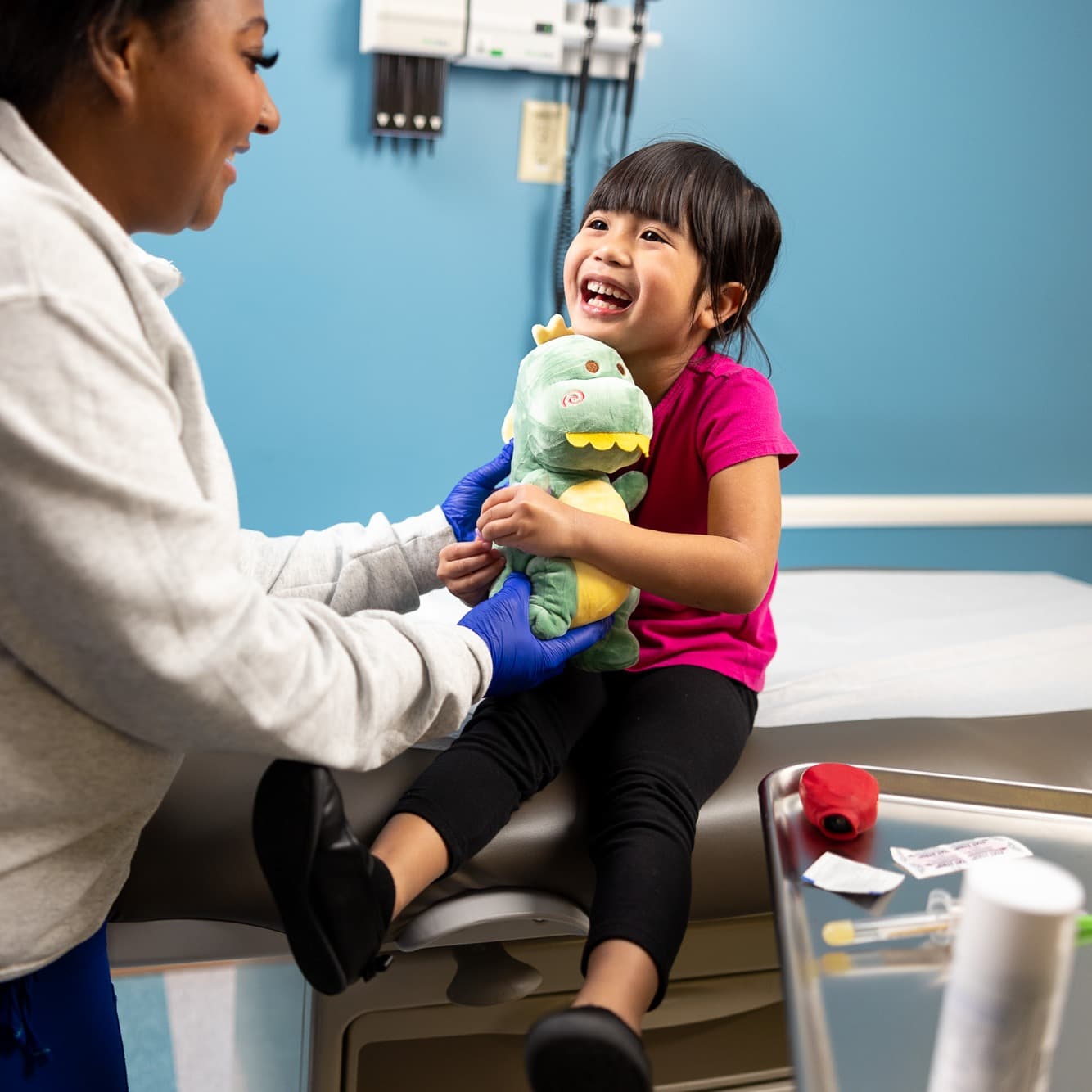 Children's Nebraska provider making a young patient smile.