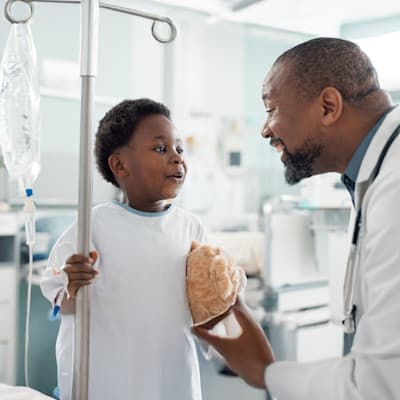 Doctor visiting patient in hospital room.
