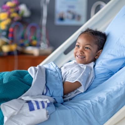 Young patient in hospital bed.