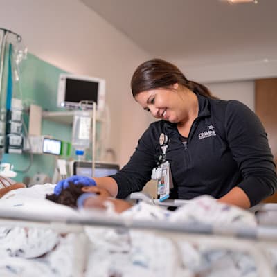 Provider caring for young PICU patient.