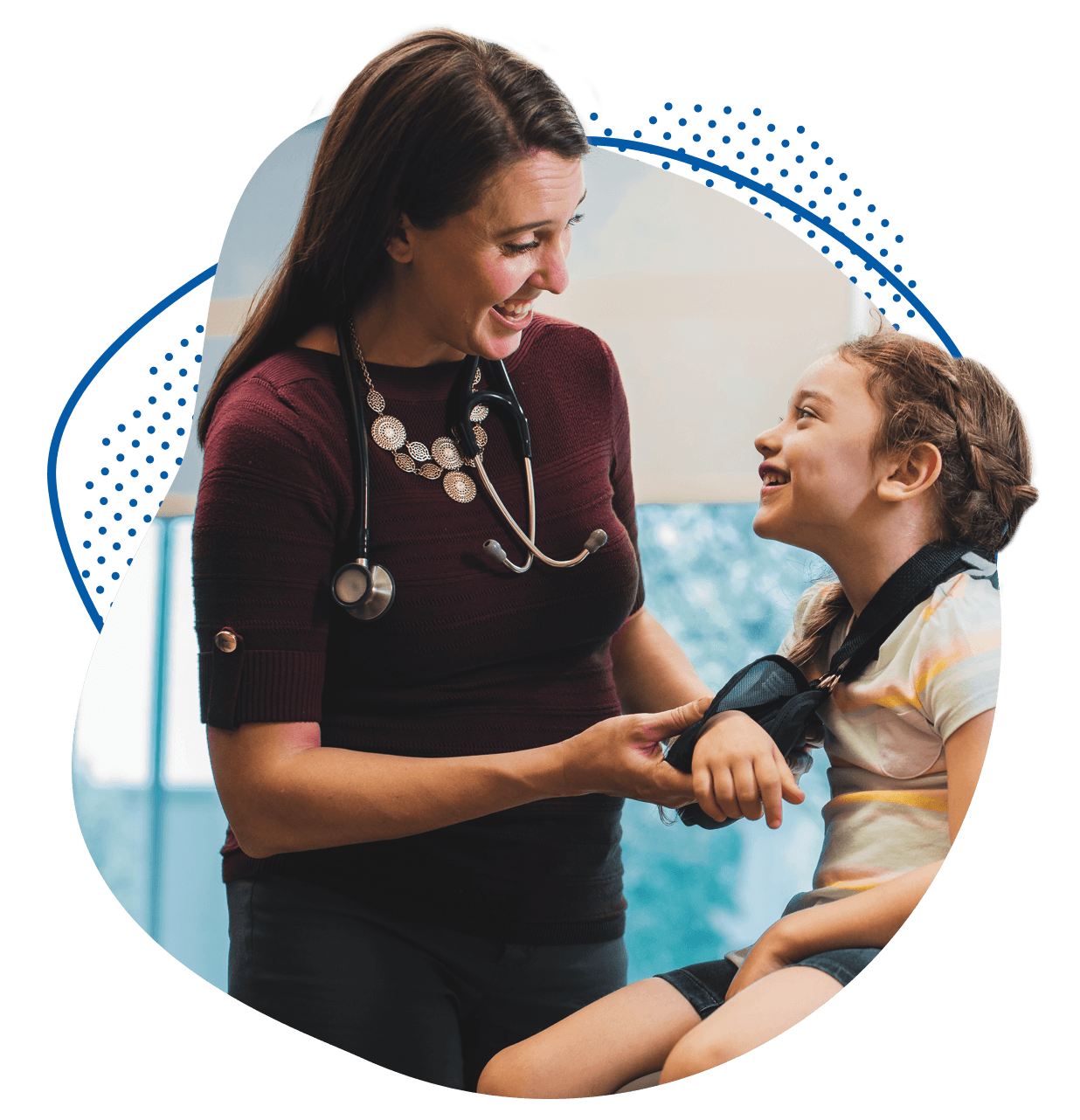 Children's provider fitting young patient with an arm sling.