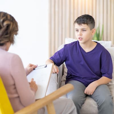 Therapist talking to teenage boy.