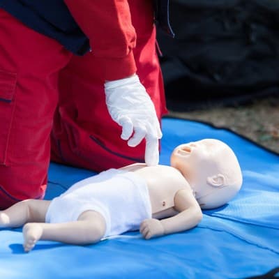 Emergency provider training for pediatric life support with infant doll.
