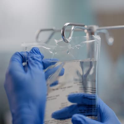 IV bag hanging from pole.